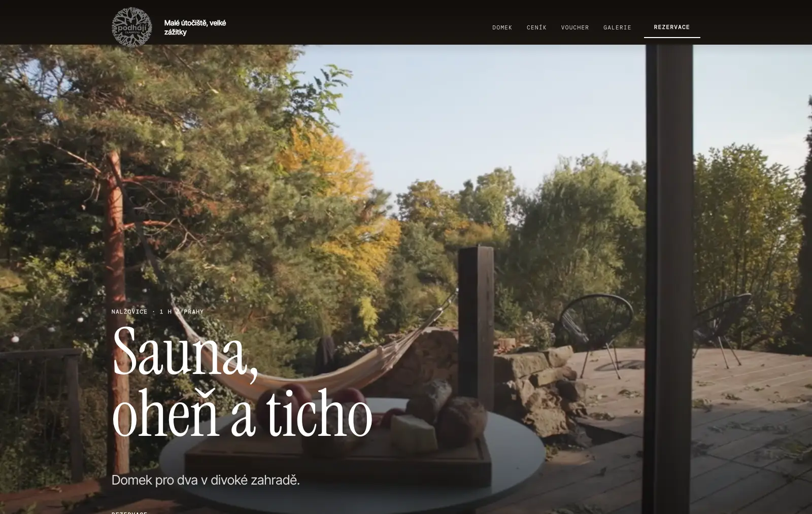 Web ubytování v šabloně Film: fotka domku v zahradě přes celou šířku, tmavé menu a nadpis přímo na fotce (ukázka glampingu Podhájí)